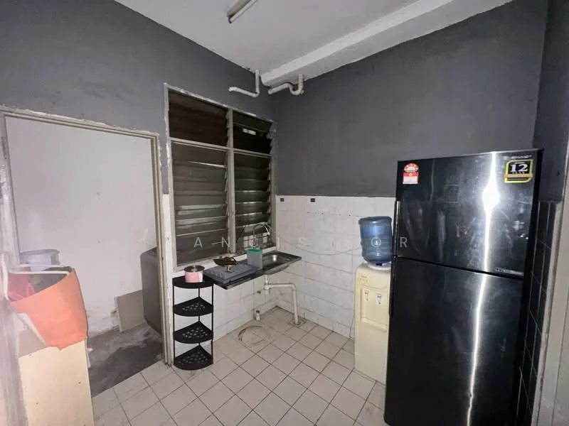 Kitchen features: grey painted walls, white tiled backsplash, ceramic tile flooring, stainless-steel fridge, water dispenser, sink with countertop, kitchen cabinets, window with metal grilles.