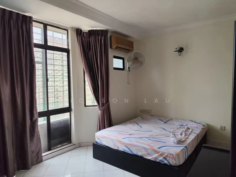 Bedroom features: queen-size bed with patterned bedding, floor-to-ceiling windows, dark brown curtains, white painted walls, air conditioning unit, wall-mounted fan, tile flooring, light fixture on wall.