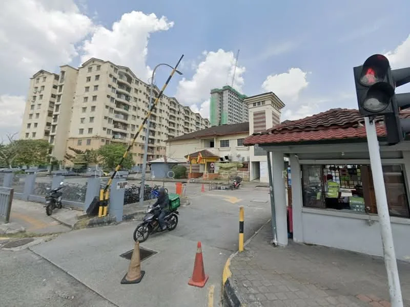 Exterior type: mid-rise condominium; features: multiple-storey buildings, residential complex, surrounding greenery, road access, traffic light, guard house at entrance, paved driveway, parking area; style: modern.