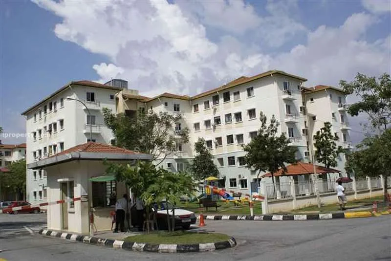 Exterior type: low-rise apartment block; features: white painted facade, flat roof, approximately 3-storey, manicured lawn, mature trees, playground visible in background, guard house at entrance, paved driveway, parking lot, surrounded by greenery; style: modern.