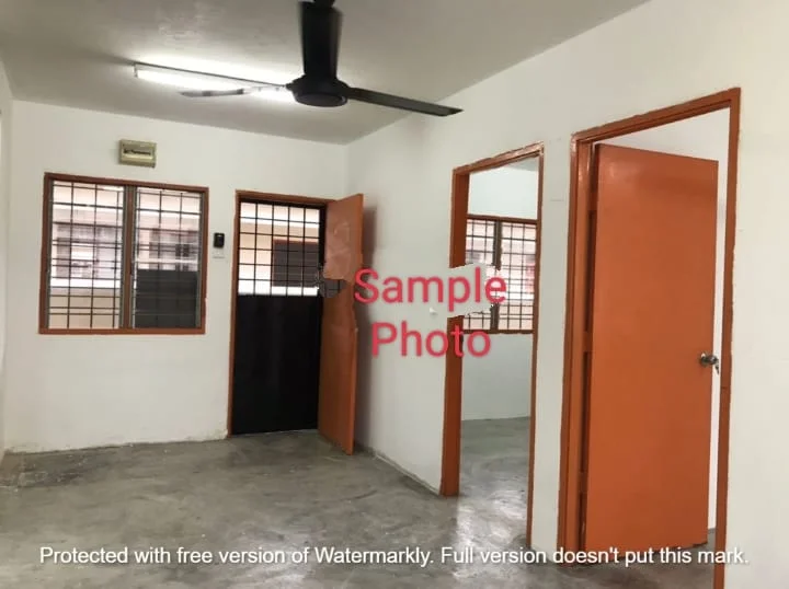 Room features: white painted walls, grey concrete flooring, 5-blade ceiling fan, two wooden doors with orange paint, grilled windows, one wall-mounted light fixture, no visible furniture; style: minimalist.