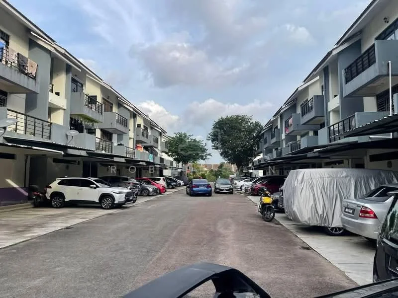 Exterior type: linked terrace house; features: two-storey linked terrace houses, grey painted facade, balconies with black railings, manicured landscaping, paved driveway, multiple parking spaces, surrounded by trees, cloudy sky, vehicles parked in front, street view; style: modern.