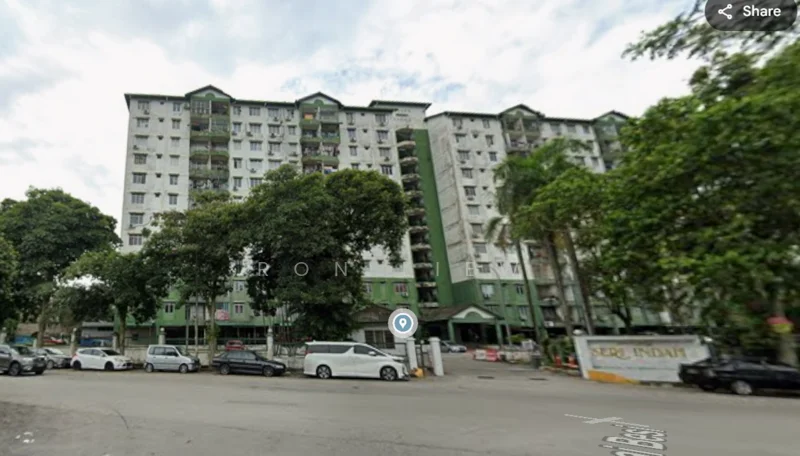 Exterior type: mid-rise condominium; features: green painted facade, multiple balconies, 5-storey building, surrounded by trees, parking area visible, main entrance gate, guard house at entrance; style: modern.