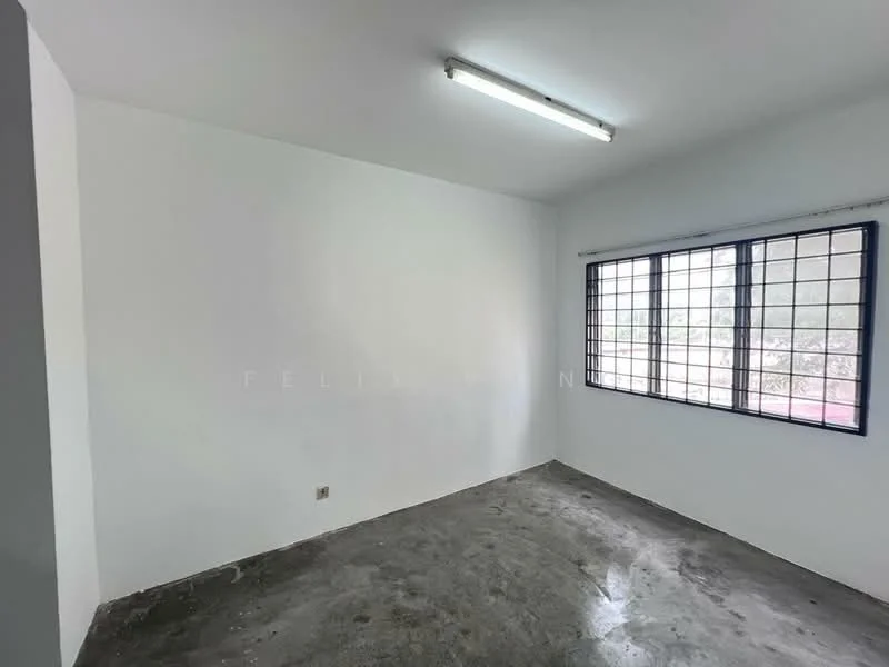 Room features: white painted walls, concrete flooring, single window with security bars, fluorescent ceiling light.