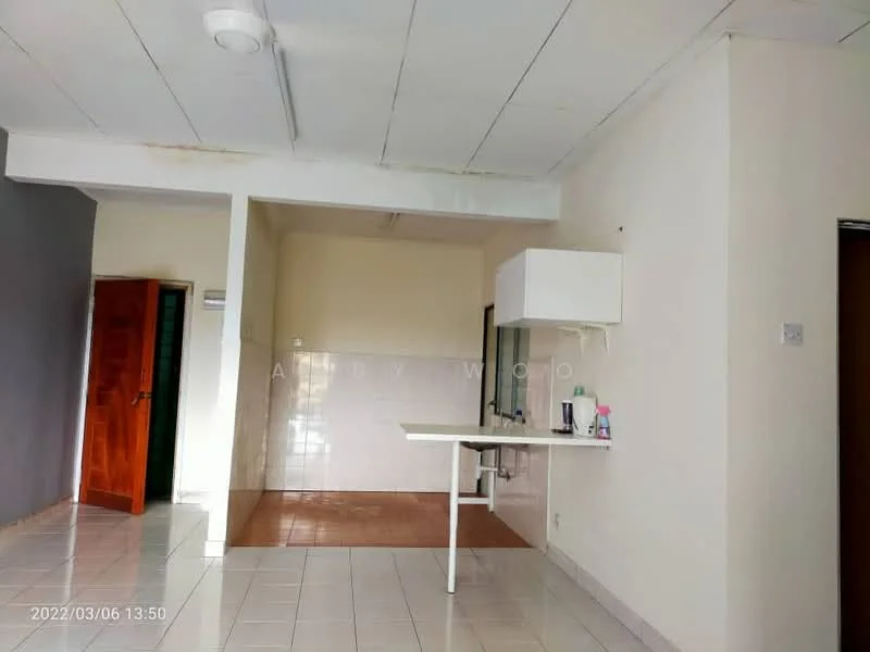 Room features: white painted walls, grey accent wall, white ceiling, tile flooring, kitchenette with sink, countertop, wall-mounted cabinet, door to another room, window, light fixture.