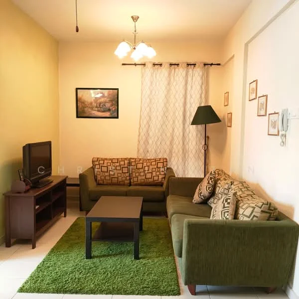 Living features: green fabric sofa, 2-seater sofa with patterned cushions, 3-seater sofa with patterned cushions, black coffee table, TV console with television, area rug in green, white walls, green accent wall, curtains with floral pattern, ceiling light fixture with three bulbs, wall-mounted artwork, floor lamp with green shade; style: contemporary.