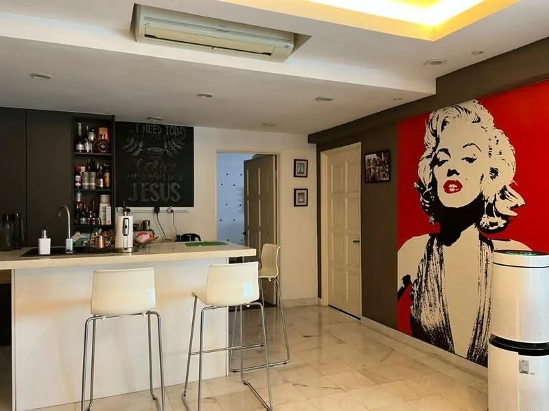 Kitchen features: marble tile flooring, white walls, black cabinetry, kitchen island with seating, stainless-steel appliances, refrigerator, built-in oven, countertop with bar stools, decorative wall art, air conditioning unit, pendant lighting, open shelving, wine rack; style: modern.