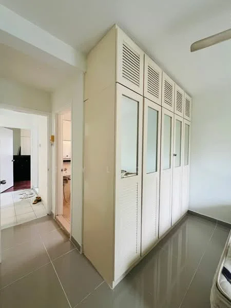 Room features: built-in wardrobe with glass doors, cream cabinetry, ventilated panels, grey tiled flooring, white walls, ceiling fan; style: modern.