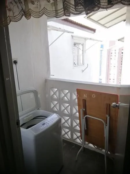 Room features: washing machine, folding drying rack, white walls, tile flooring, balcony railing, overhead awning, decorative wall panel, curtains.
