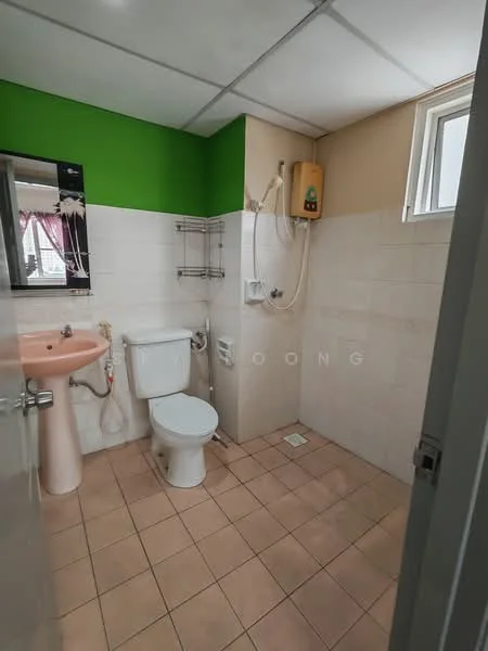 Bathroom features: green painted accent wall, white tiled walls, beige tiled flooring, single-sink vanity with pink basin, mirror above vanity, toilet, shower with wall-mounted water heater, window for natural light, towel rack.