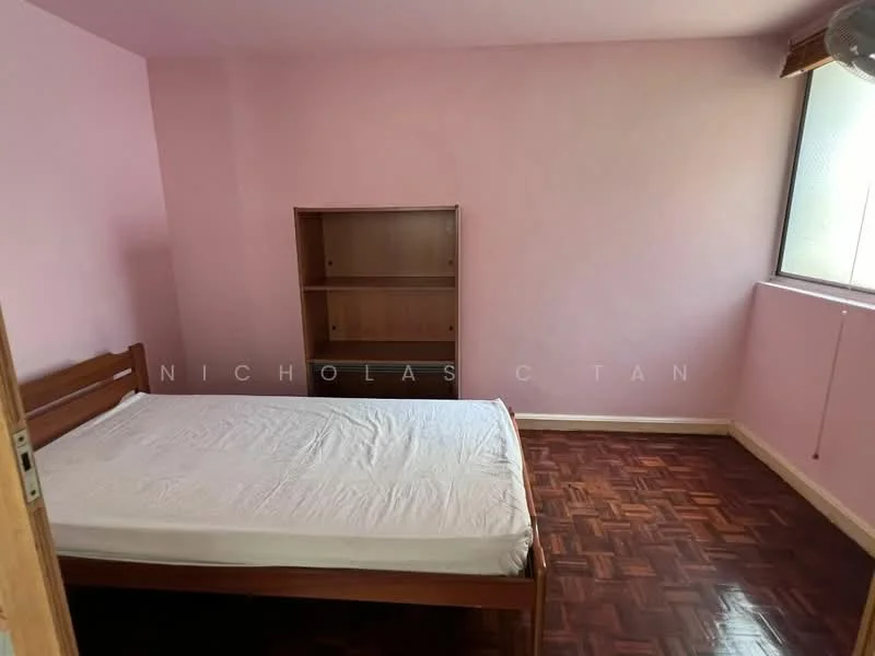 Bedroom features: pink painted walls, parquet wood flooring, single bed frame, empty mattress, built-in wooden shelf, window with natural light.