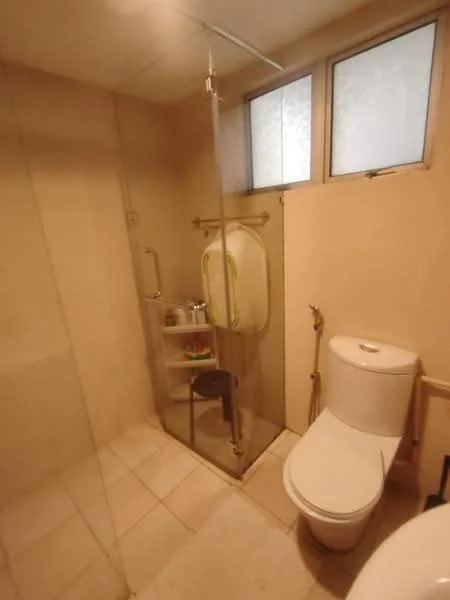 Bathroom features: walk-in shower with glass enclosure, chrome handheld shower, single-sink vanity with white cabinet, one-piece toilet, tile flooring, cream tiled walls, frosted glass windows, shower shelf, wall-mounted towel rack; style: modern.