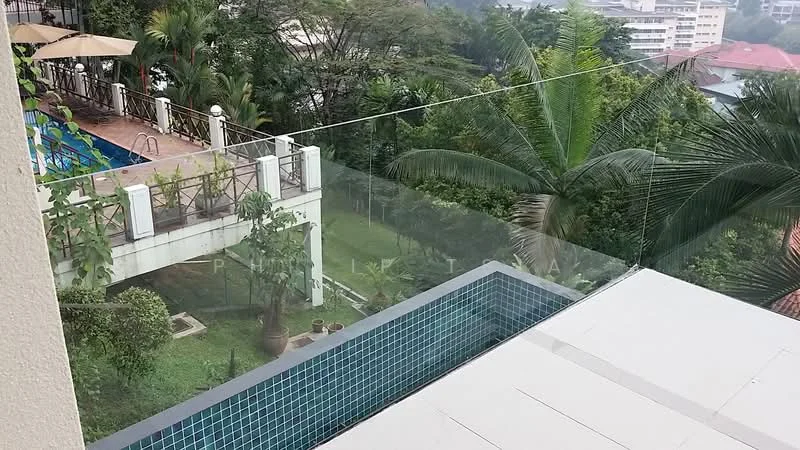 Exterior type: high-rise condominium; features: infinity pool, pool deck with loungers, manicured lawn, tropical landscaping, glass railing, surrounded by greenery, view of nearby buildings; style: modern.