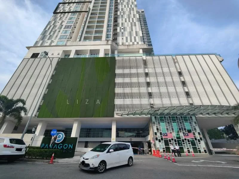 Exterior type: high-rise condominium; features: glass curtain wall, green vertical garden feature, white painted facade, projecting balconies, multi-storey structure, main entrance with glass doors, landscaped area at entrance, parking area visible, signage for 'PARAGON', surrounded by palm trees; style: modern.