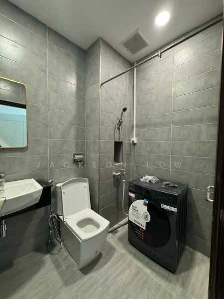 Bathroom features: grey tiled walls, grey tiled flooring, single-sink vanity with wall-mounted faucet, framed mirror, one-piece toilet, handheld shower, shower head, front-load washing machine; style: modern.