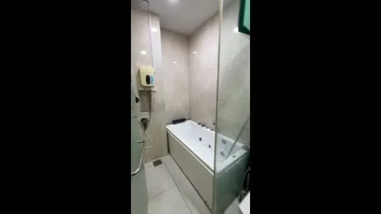 Bathroom features: built-in bathtub with jets, glass shower enclosure, cream tiled walls, light grey tiled flooring, wall-mounted shower head, handheld shower, chrome faucet, soap dispenser, recessed lighting; style: modern.