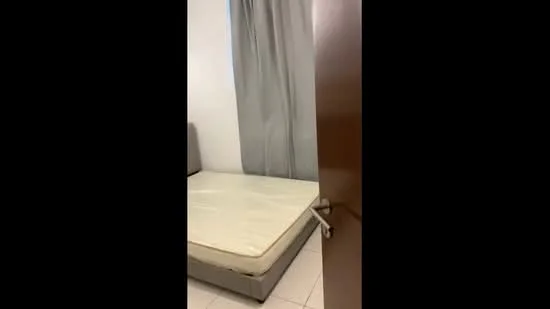 Bedroom features: single bed mattress, grey upholstered bed frame, white walls, light grey curtains, tile flooring, wooden door, window, minimal decor; style: minimalist.