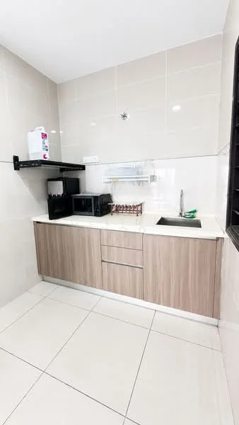 Kitchen features: light grey tiled walls, white tiled backsplash, light wood cabinetry, single-bowl stainless-steel sink, chrome pull-down faucet, white countertop, black microwave, black countertop oven, open shelving, ceramic tile flooring, green dish rack; style: modern.