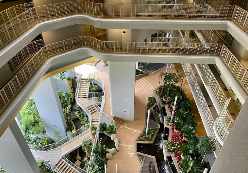 Exterior type: mid-rise condominium; features: interior garden with landscaping, water features with fountains, multiple levels with walkways, balconies overlooking garden, decorative planters, natural stone pathways, lush greenery and plants, open atrium design, railings along walkways, modern architectural elements; style: modern.