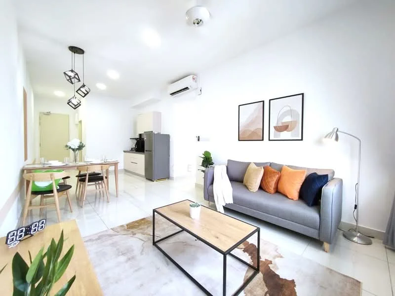 Living features: grey fabric sofa, decorative cushions in orange and beige, wooden coffee table, area rug with abstract pattern, floor lamp, wall-mounted TV, white painted walls, recessed ceiling lights, sliding glass door, dining table with 4 chairs, kitchenette visible in background, air conditioning unit; style: modern. Dining features: wooden dining table, 4 wooden dining chairs, white painted walls, recessed ceiling lights; style: modern.