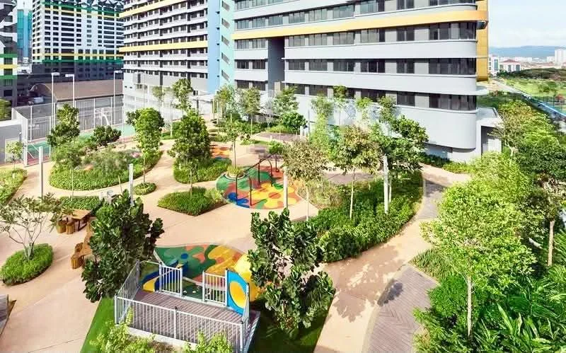 Exterior type: high-rise condominium; features: landscape garden, children's playground, manicured lawn, mature trees, paved walkways, outdoor seating areas, colorful play surfaces, surrounded by greenery; style: modern.