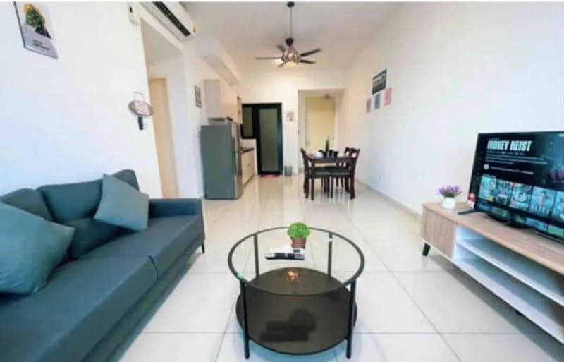 Living features: 3-seater fabric sofa in grey, round glass coffee table, wall-mounted TV, TV console, ceiling fan, white painted walls, tile flooring, decorative plant on coffee table, area rug, dining table with chairs visible in background, kitchen area visible in background; style: modern.