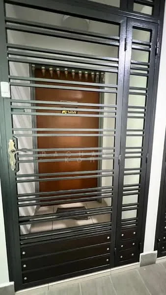 Exterior features: metal security gate with horizontal bars, wooden main door with a number plate, tiled flooring, light-colored wall, door handle, security lock, intercom panel, door frame with decorative elements; style: modern.