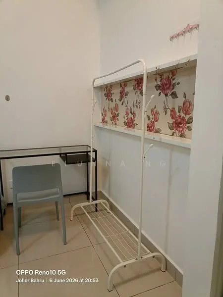 Room features: white painted walls, floral wallpaper, tile flooring, metal clothing rack, small desk, grey chair; style: modern.