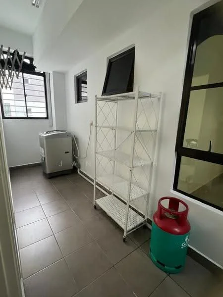 Laundry features: grey washing machine, white metal shelving unit, green gas cylinder, white painted walls, tile flooring in grey, black-framed windows, natural light from windows.