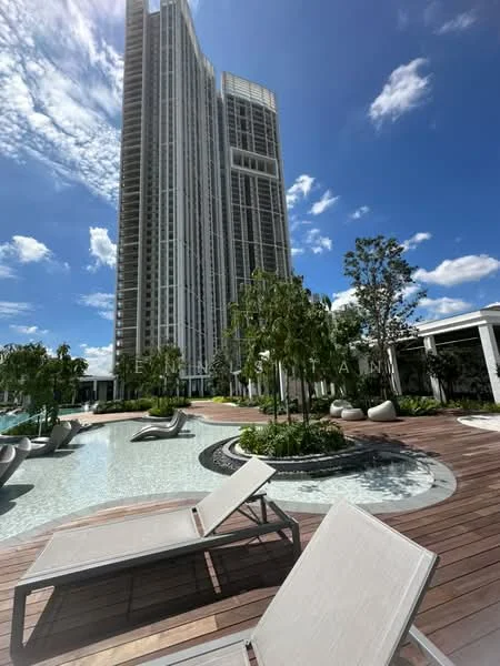 Exterior type: high-rise condominium; features: infinity pool, pool deck with loungers, landscaped garden, mature trees, wooden decking, modern architectural design, glass curtain wall, surrounded by greenery; style: modern.