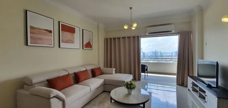 Living features: L-shape sectional sofa in light grey, orange accent cushions, coffee table with round top, wall-mounted TV, TV console in white, floor-to-ceiling windows, curtains in beige, decorative wall art in frames, polished tile flooring, ceiling light fixture with multiple bulbs, air conditioning unit; style: modern; view: city.