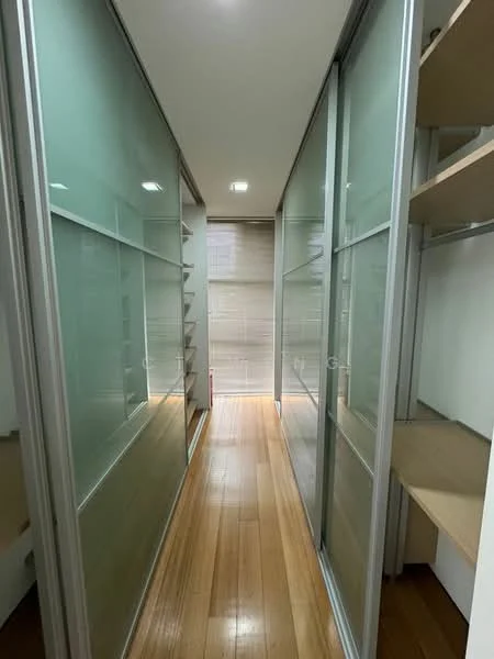 Room features: glass sliding doors, wooden flooring, built-in shelves, neutral wall color, recessed lighting, narrow hallway, natural light from window, minimalist design; style: modern.