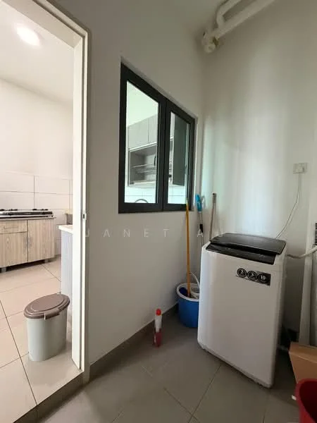 Laundry features: white front-load washing machine, grey tiled flooring, white walls, small trash bin, cleaning supplies, window with black frame, built-in cabinetry, countertop, light source, shelf with cleaning tools.