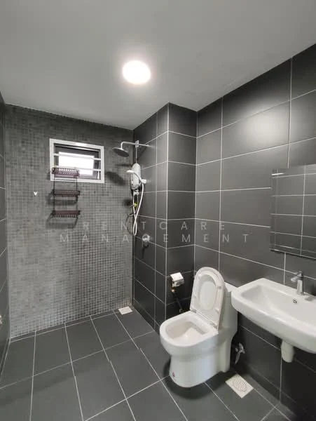 Bathroom features: grey tiled walls, black tiled flooring, shower area with handheld shower, wall-mounted showerhead, toilet, single-sink vanity, mirror above sink, window for natural light, wall-mounted storage rack; style: modern.