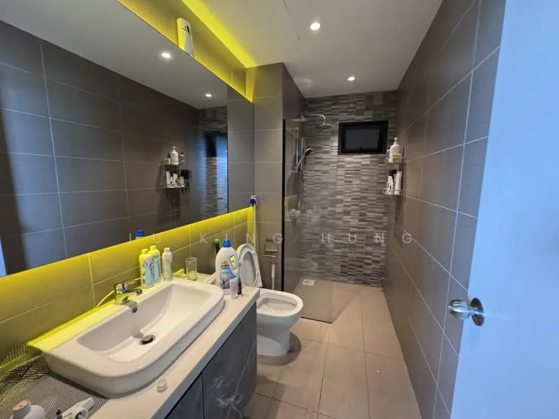 Bathroom features: single-sink vanity with grey cabinet, white ceramic sink, chrome basin mixer faucet, wall-mounted mirror, one-piece toilet, walk-in shower with glass enclosure, rain shower head, grey tiled walls, mosaic tile accent wall, tile flooring, recessed LED lighting, yellow LED strip lighting, shelves for toiletries; style: modern.