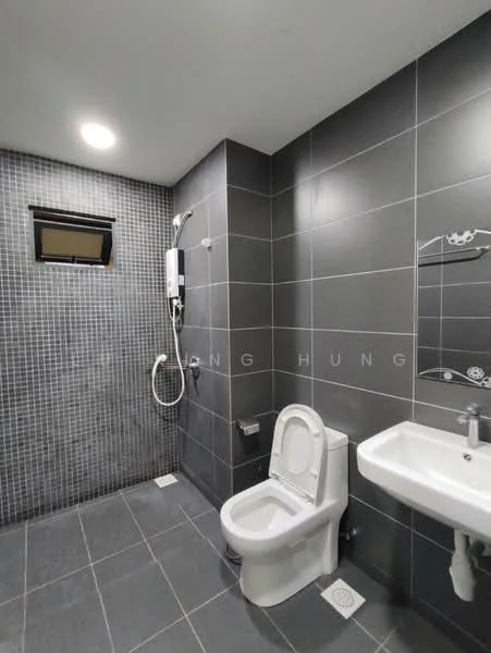Bathroom features: grey tiled walls, black tiled flooring, wall-mounted shower head, handheld shower, toilet, single-sink vanity, mirror above sink, window for natural light, shower with glass partition, built-in soap holder, towel rail; style: modern.