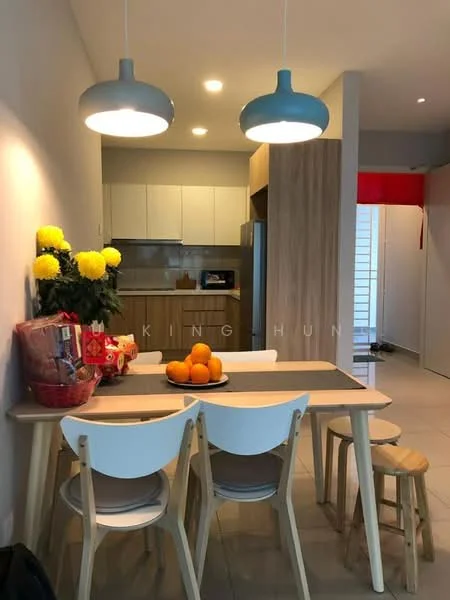 Dining features: wooden dining table, 4 white dining chairs, 2 wooden stools, yellow flowers in vase, fruit bowl with oranges, pendant lighting with blue shades, cream painted walls, tile flooring, built-in cabinetry, stainless-steel fridge visible in background, kitchen area with white cabinets; style: modern.