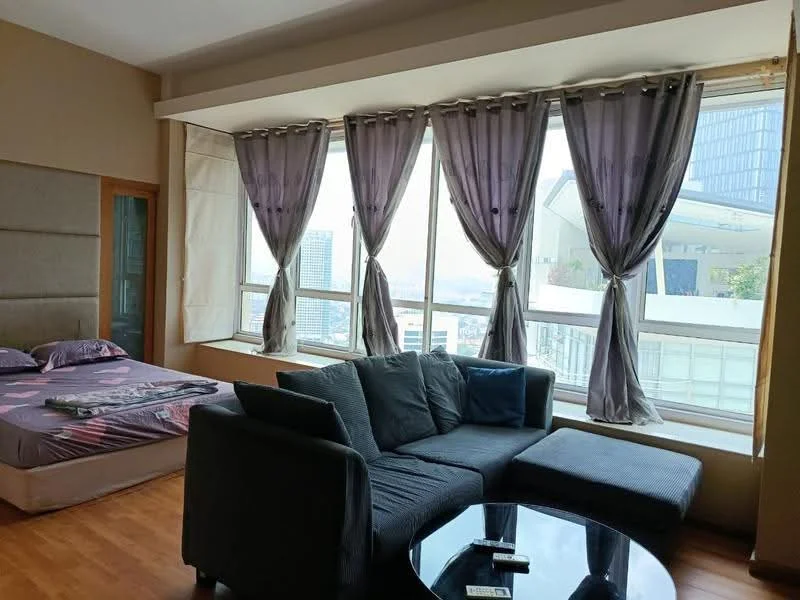 Living features: large floor-to-ceiling windows, grey fabric sofa, round glass coffee table, wooden flooring, curtains in grey, decorative cushions, city view, open layout; style: modern; view: city. Bedroom features: queen-size bed, bedding with floral pattern, upholstered headboard, wooden flooring, curtains in grey; style: modern; view: city.