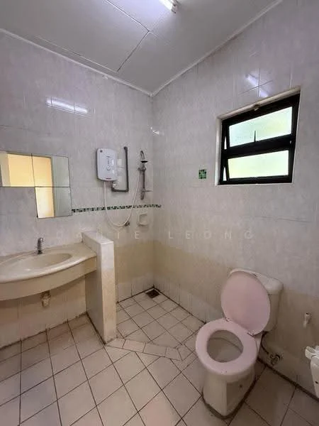 Bathroom features: white tiled walls, light grey tiled flooring, single-sink vanity with circular basin, chrome basin mixer faucet, framed mirror above sink, toilet with pink seat, shower with handheld showerhead, window with black frame, wall-mounted water heater, tile cladding around shower area.
