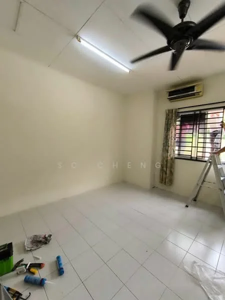 Room features: white painted walls, white ceiling, ceiling fan, wall-mounted split AC, tile flooring, window with black metal grille, curtains, ladder, paint supplies on floor.