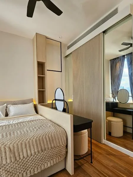 Bedroom features: queen-size bed with textured beige bedding, wooden flooring, built-in wardrobe with sliding mirror doors, wooden accent wall, ceiling fan with 3 blades, desk with round mirror, upholstered stool, ambient lighting under the bed, curtains in grey fabric, window with city view; style: modern; view: city.