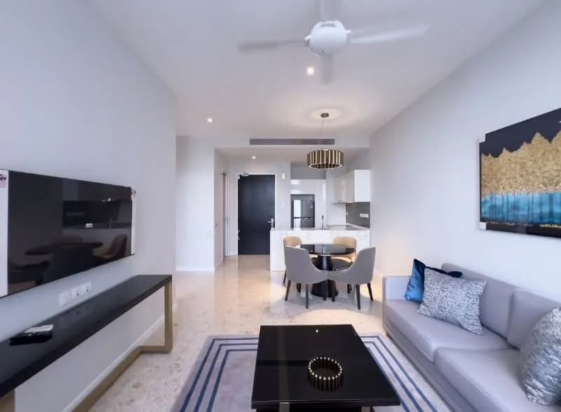Living features: 3-seater fabric sofa in light grey, coffee table with black surface, wall-mounted TV, TV console with storage, ceiling fan with light, recessed downlights, decorative wall art, area rug with geometric pattern, large window with natural light; style: modern. Dining features: round dining table, upholstered dining chairs, open kitchen layout, kitchen island with seating; style: modern.