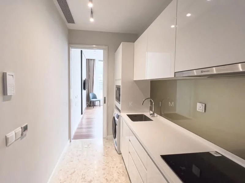 Kitchen features: white cabinetry, marble countertop, stainless-steel sink, chrome pull-down faucet, built-in oven, induction hob, washing machine, recessed downlights, grey backsplash, open layout, smooth flooring, wall-mounted electrical outlets, doorway leading to living area; style: modern.