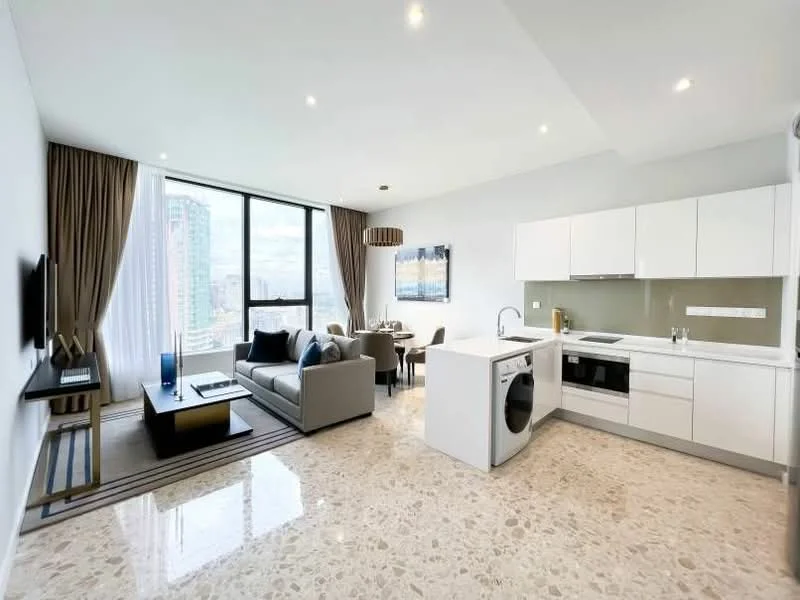 Living features: marble tile flooring, floor-to-ceiling windows, grey fabric sofa, coffee table, wall-mounted TV, TV console, area rug with geometric pattern, dining table for four, pendant light, curtains, kitchen island with sink, white cabinetry, built-in oven, stainless-steel fridge, washer-dryer combo; style: modern; view: city.