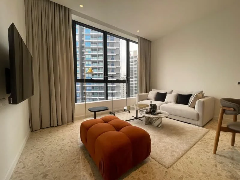 Living features: floor-to-ceiling windows, beige fabric sofa, black and white decorative cushions, round coffee table, orange ottoman, area rug, light-colored walls, curtains, wall-mounted TV, light-colored flooring; style: modern; view: city.
