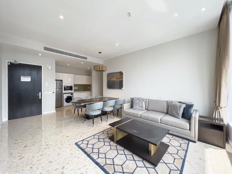 Living features: grey fabric sofa, coffee table with black top and gold base, area rug with geometric pattern, wall-mounted TV, dining table for six with upholstered chairs, pendant light fixture, marble flooring, floor-to-ceiling windows with sheer curtains; style: modern. Kitchen features: white cabinetry, built-in oven, stainless-steel fridge, washing machine, ceramic tile backsplash, countertop with integrated sink; style: modern.