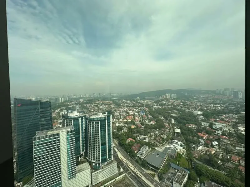 Exterior type: high-rise condominium; features: glass curtain wall, approximately 20-storey high-rise, urban skyline view, surrounded by mature greenery, adjacent to highway; style: modern.