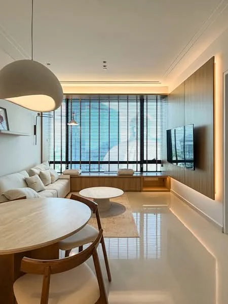 Living features: light-colored sectional sofa with cushions, round wooden coffee table, wooden dining table, wooden dining chairs, wall-mounted TV, built-in wooden cabinetry, recessed lighting, pendant light fixture, floor-to-ceiling windows with blinds, glossy tile flooring, decorative wall paneling, area rug; style: modern; view: city.