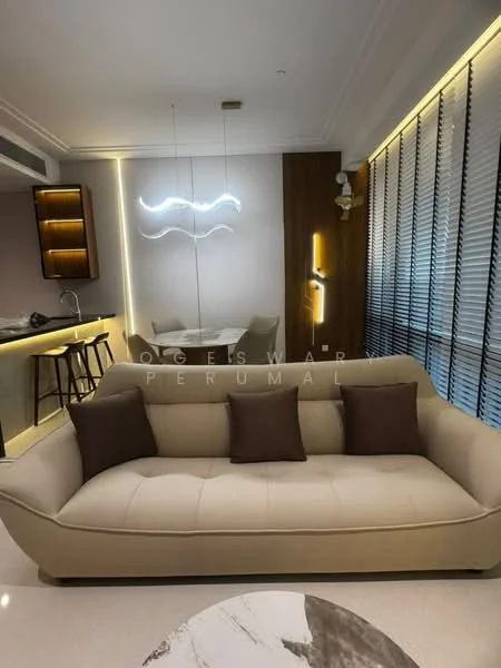 Living features: beige leather sofa with two brown cushions, round marble coffee table, wall-mounted decorative light fixture, recessed LED lighting, wooden accent wall, floor-to-ceiling windows with blinds, bar counter with high stools, mirrored wall, neutral wall color, polished tile flooring; style: modern.