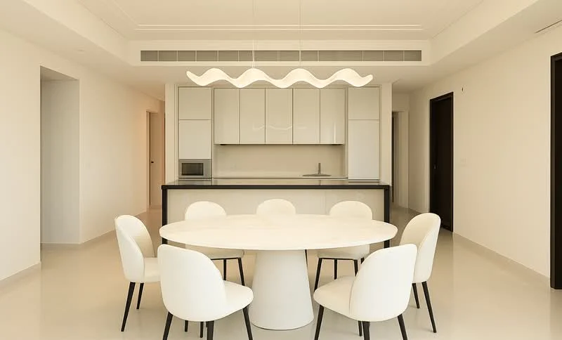Dining features: round dining table with marble top, 6 upholstered dining chairs in white, pendant light fixture with wavy design, white painted walls, cream tile flooring, built-in cabinetry with glossy finish, black countertop, open kitchen layout, floor-to-ceiling windows, recessed ceiling lights, air conditioning vent; style: modern. Kitchen features: built-in microwave, stainless-steel sink, chrome pull-down faucet, white shaker cabinets, black countertop; style: modern.